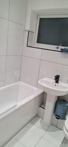 a bathroom with a sink and a toilet and a tub at 3 Bedroom Home - Nerby City Centre in Nottingham