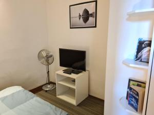 a room with a bed and a tv and a fan at Feeling home in the heart of Budapest in Budapest