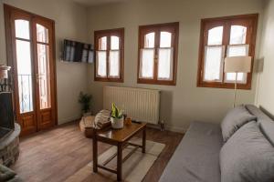 a living room with a couch and a table at The Fern House in Makrinitsa +38 photos