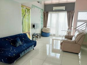 a living room with a bed and a couch and a chair at De Centrum Duplex Apartment near Bangi, Kajang in Kajang