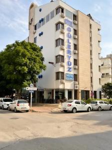 a building with cars parked in front of it at Hotel Güleryüz 2 in Antalya