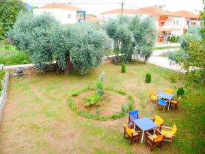 an overhead view of a garden with tables and chairs at Blue Sky Apartments in Skala Potamias +34 photos