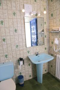 a bathroom with a sink and a toilet and a mirror at Pensió Solivent in L'Escala