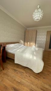 a bedroom with a bed and a chandelier at На Тархана in Astana