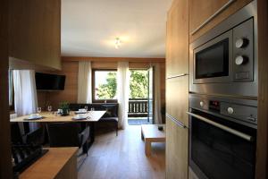 a kitchen with a table and a dining room at Zell am See Lake View Apartment in Zell am See