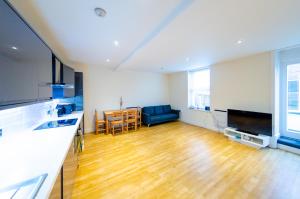 a kitchen and living room with a wooden floor at Large Apartment 2 Bedrooms - 2 Bathrooms in Ipswich