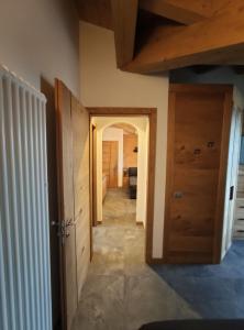 a hallway leading into a room with a door at Al Toscana in Andalo +188 photos