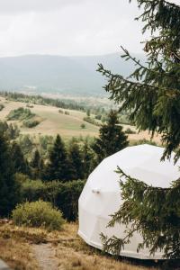 a white tent sitting on top of a hill at Mandra Hills in Richka
