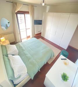 a bedroom with a large bed and a table at Casa Relax con Terrazza Panoramica in Fiumicino
