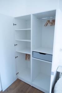 a walk in closet with white shelves at au42dotBzh in Saint-Brieuc