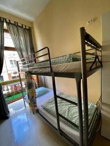 two bunk beds in a room with a window at Ametyst Hostel in Krakow