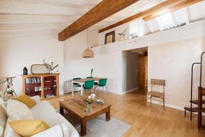 a living room with a white couch and a table at Atico vistas Estafeta,centro historico in Pamplona +14 photos