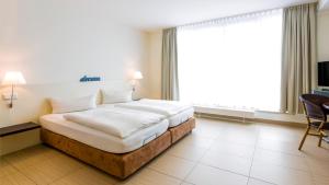 Un pat sau paturi într-o cameră la Michels Villa Nordsee