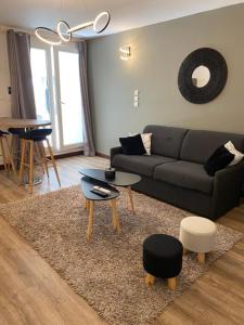 a living room with a couch and a table at Le Margoze - T2 Boucan Canot in Saint-Gilles les Bains