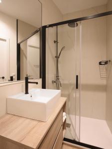 a bathroom with a white sink and a shower at Luxury flat next to Gran Via Madrid in Madrid