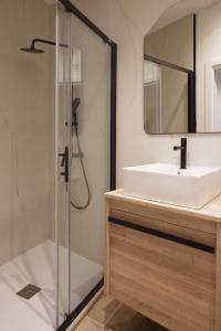 a bathroom with a sink and a shower at Luxury flat next to Gran Via Madrid in Madrid