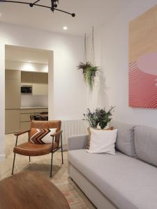 a living room with a couch and a table at Luxury flat next to Gran Via Madrid in Madrid