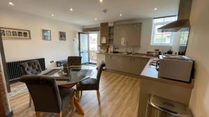 a kitchen and dining room with a table and chairs at Chapel Row 2 in Wirksworth