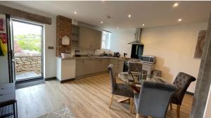 a kitchen and dining room with a table and chairs at Chapel Row 2 in Wirksworth +16 photos