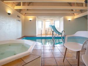 łazienka z wanną i basenem w obiekcie 10 person holiday home in Bl vand w mieście Blåvand