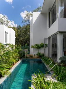 a swimming pool in the backyard of a house at La Avila, 2 BHK Villas near Morjim Beach with Private Pool, Kitchen, Balcony &Security in Siolim