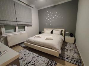 a bedroom with a large bed and a window at Estrela Comfortable Home in Volos