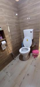 a bathroom with a white toilet in a room at Corbett Nature Retreat in Rāmnagar