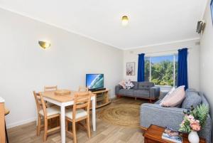 a living room with a table and a couch at Victor Seaside Villa in Victor Harbor