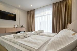 Letto o letti in una camera di Olimp Hotel