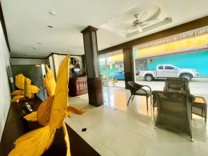 a living room with a ceiling fan and a table and chairs at Hill View Lodge in Patong Beach