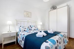 a bedroom with a bed with towels on it at Mar de Lava Sunrise Fuerteventura in Pozo Negro