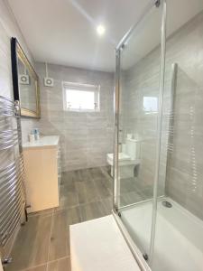 a bathroom with a shower and a toilet and a sink at BEA Elcot Close in Manchester