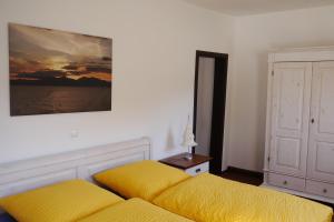 a bedroom with two beds and a painting on the wall at Cafe Hotel Aroma Moselblick in Burgen
