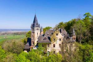 an old castle sitting on top of a hill at Seenswert - ein Wohlfühlort, in dem ALLE herzlich willkommen sind in Pähl
