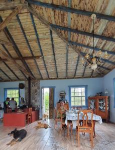 a living room with a table and some cats laying on the floor at Recanto Bom Despacho in Tiradentes