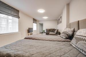 ein Schlafzimmer mit einem großen Bett und einem Sofa in der Unterkunft Central Platinum Apartments 19 in Rybnik