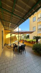 a patio with a table and chairs and an umbrella at Terra mia in Naples