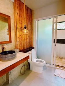 a bathroom with a toilet and a sink at Crystal Bali Style in Salad Beach