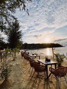 a group of tables and chairs on the beach at Crystal Bali Style #6 in Salad Beach