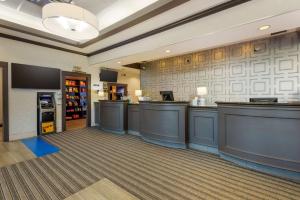 a bar in a restaurant with a cash register at Best Western Plus Village Park Inn in Calgary