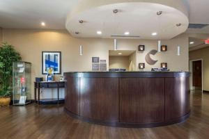 a lobby with a large wooden counter in a hospital at Comfort Suites Huntersville near Lake Norman in Huntersville +50 photos