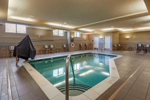 a large swimming pool in a hotel lobby at Comfort Suites Lake Norman - Huntersville in Huntersville