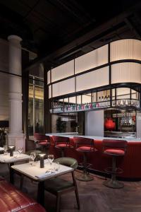 a restaurant with tables and chairs and a bar at Radisson RED Hotel, Liverpool in Liverpool