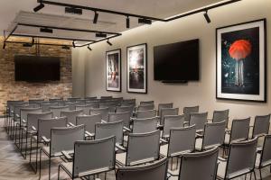 a conference room with chairs and a flat screen tv at Radisson RED Hotel, Liverpool in Liverpool
