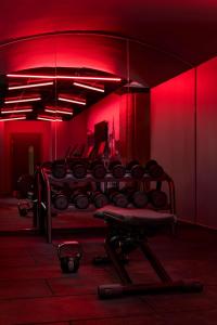 a red room with a gym with a bench in it at Radisson RED Hotel, Liverpool in Liverpool