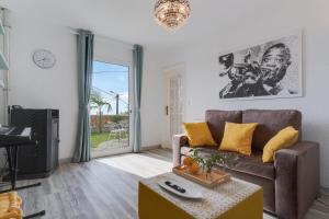 a living room with a couch and a table at Melody House of Ponta do Sol by HR Madeira in Ponta do Sol +27 photos