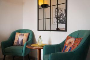 a room with two chairs and a table and a mirror at Melody House of Ponta do Sol by HR Madeira in Ponta do Sol