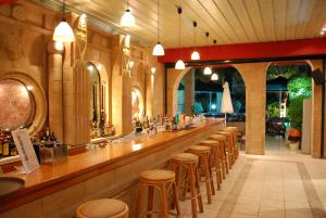 a bar with a row of stools in a restaurant at Eugenia Hotel & Apartments in Laganas