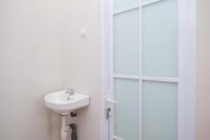 a bathroom with a sink and a shower at RedDoorz Syariah near Universitas Tidar Magelang in Magelang