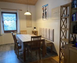 a dining room with a table and chairs and a window at Ferienhaus Brandt im Ferienpark Falkenstein in Falkenstein